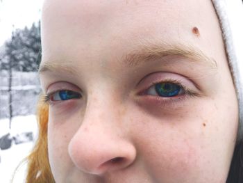 Close-up portrait of a girl with snow