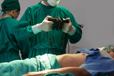 Rear view of female doctor examining patient at clinic