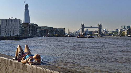 Bridge over river with city in background