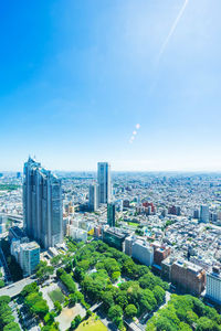 High angle view of buildings against blue sky