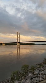 Bridge over river at sunset