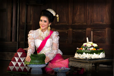 Portrait of smiling beautiful woman celebrating loi krathong