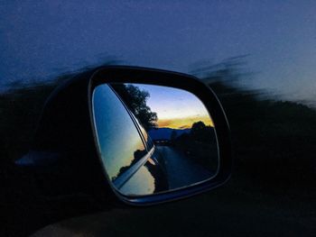 Reflection of car on side-view mirror