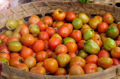 Fresh tomato - large quantities of tomato in the basket. fresh tomatoes in the market