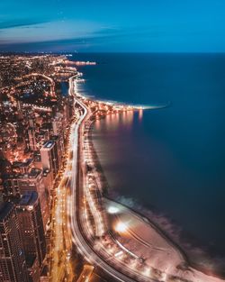 High angle view of city lit up at night