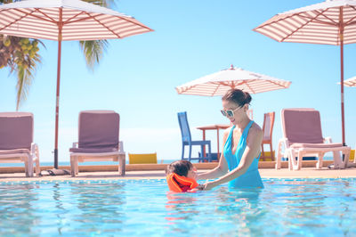 Rear view of woman swimming in pool