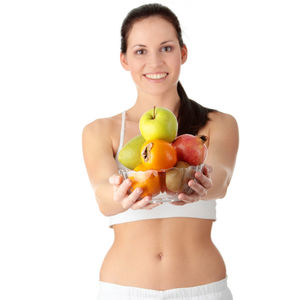 Young woman holding apple against white background