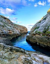 Rock formation amidst sea against sky