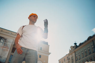 Low angle view of man standing against sky