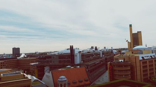 Buildings against cloudy sky