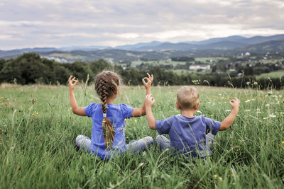 Rear view of children on field