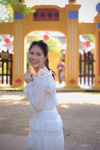 Portrait of smiling girl standing outdoors