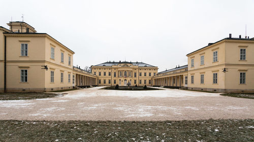 Buildings in city against clear sky