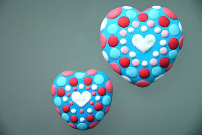Close-up of multi colored heart shape over white background