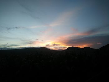 Scenic view of silhouette mountains against sky at sunset