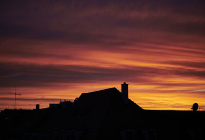 Silhouette buildings against sky during sunset