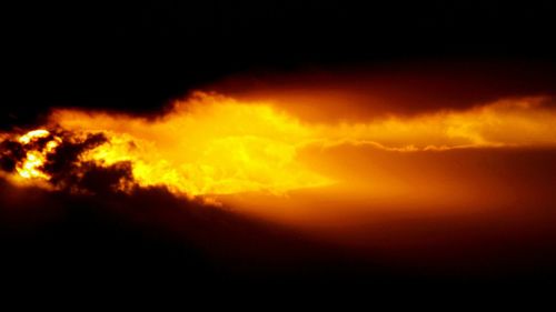 Low angle view of cloudy sky at sunset