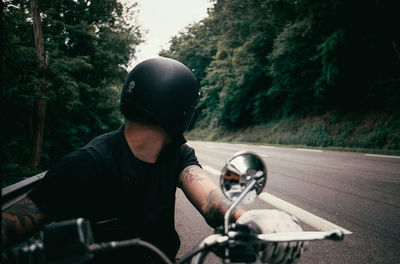 Man riding bicycle on road