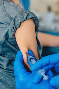 Close-up of doctor giving injection to patient