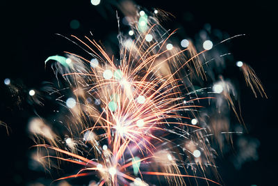 Low angle view of firework display at night