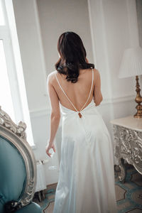 Rear view of woman standing in corridor