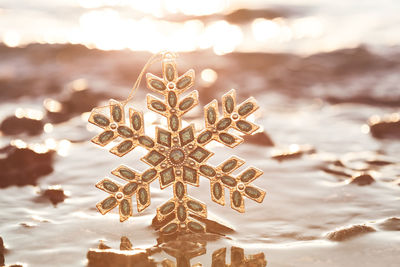 Close-up of illuminated water against sky during sunset