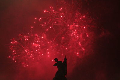 Fireworks with a contrasting statue 