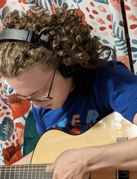 Portrait of boy playing guitar