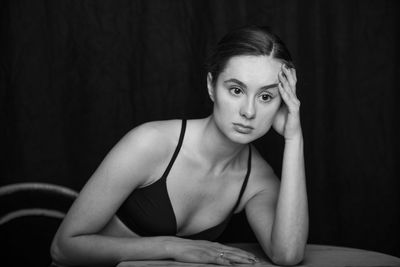 Portrait of woman sitting at home