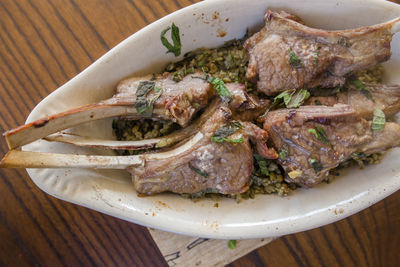 Close-up view of lebanese lamb chops and fresh mint with freekeh