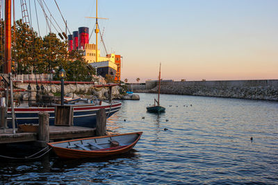 Boats moored in sea against sky