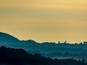 Scenic view of silhouette mountains against sky at sunset