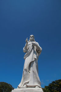 Low angle view of statue against clear blue sky