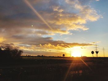Scenic view of silhouette field against sky during sunset