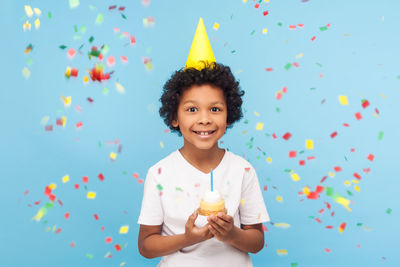 Portrait of smiling boy holding umbrella