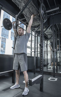 Man working out with barbells in urban gym in bangkok