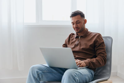 Young man using laptop at home