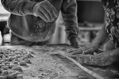 Midsection of man preparing food in kitchen