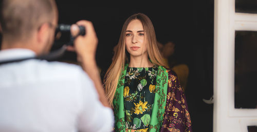 Midsection of woman holding camera