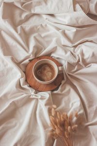 High angle view of coffee on bed