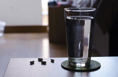 Close-up of drink and pills on table