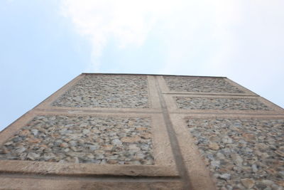 Low angle view of building against cloudy sky