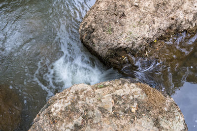 High angle view of river flowing through rocks