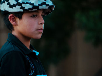 Portrait of boy looking away outdoors