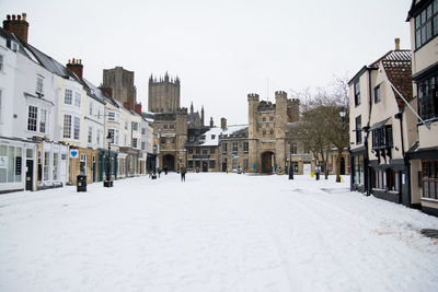 Snow covered houses in city