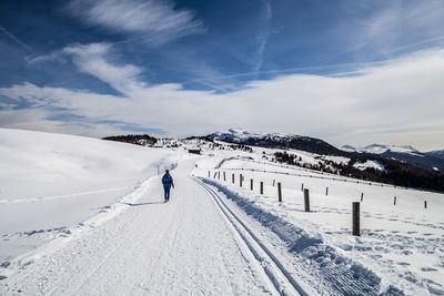 People on snow covered mountain against sky