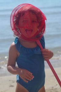 Rear view of girl standing at beach