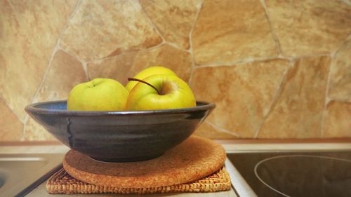 Apples in bowl on table