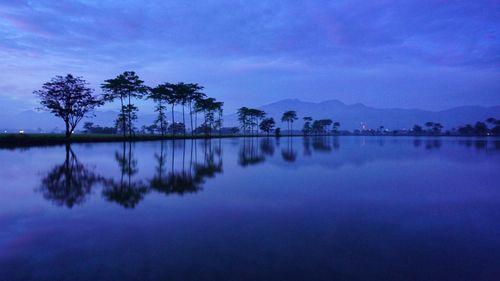 Scenic view of lake against sky at dusk