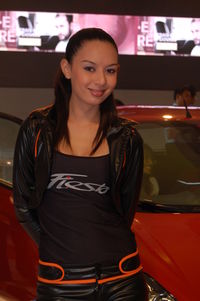 Portrait of smiling young woman standing at bus